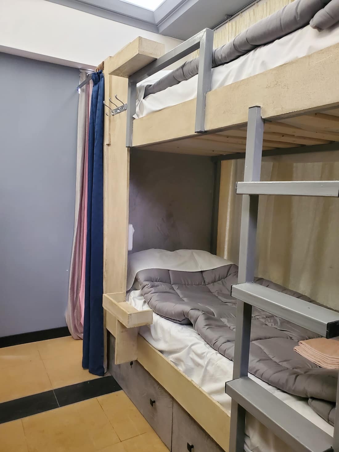 Made-up bunk beds with grey duvets