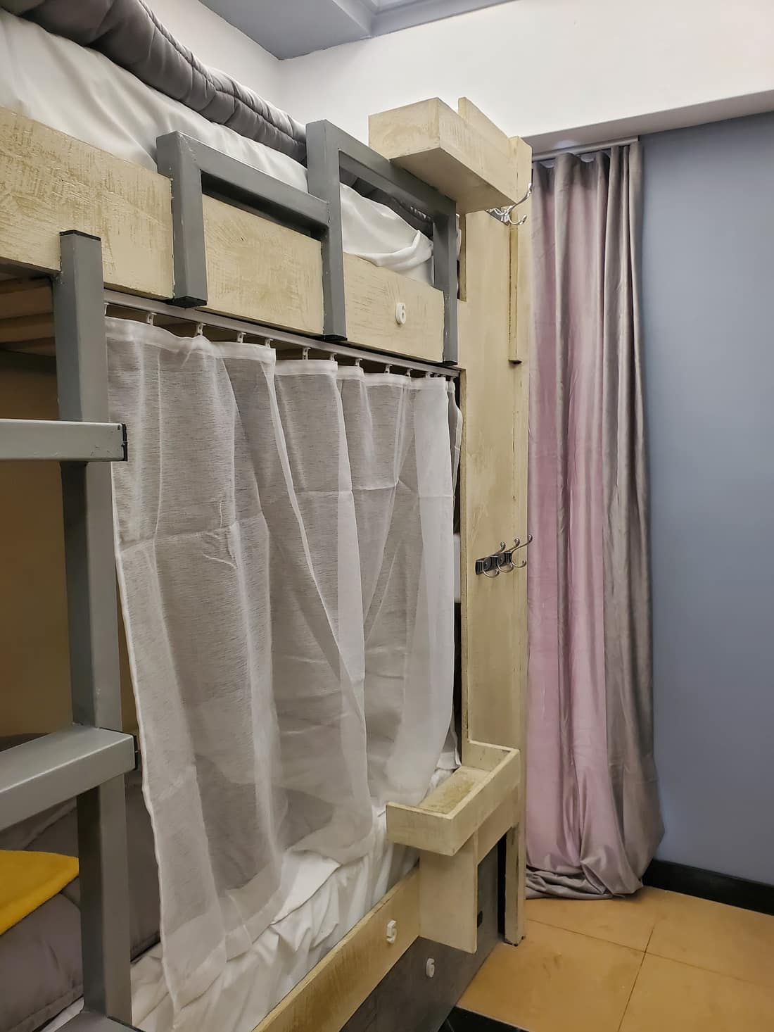 Bunk beds with white privacy curtains drawn