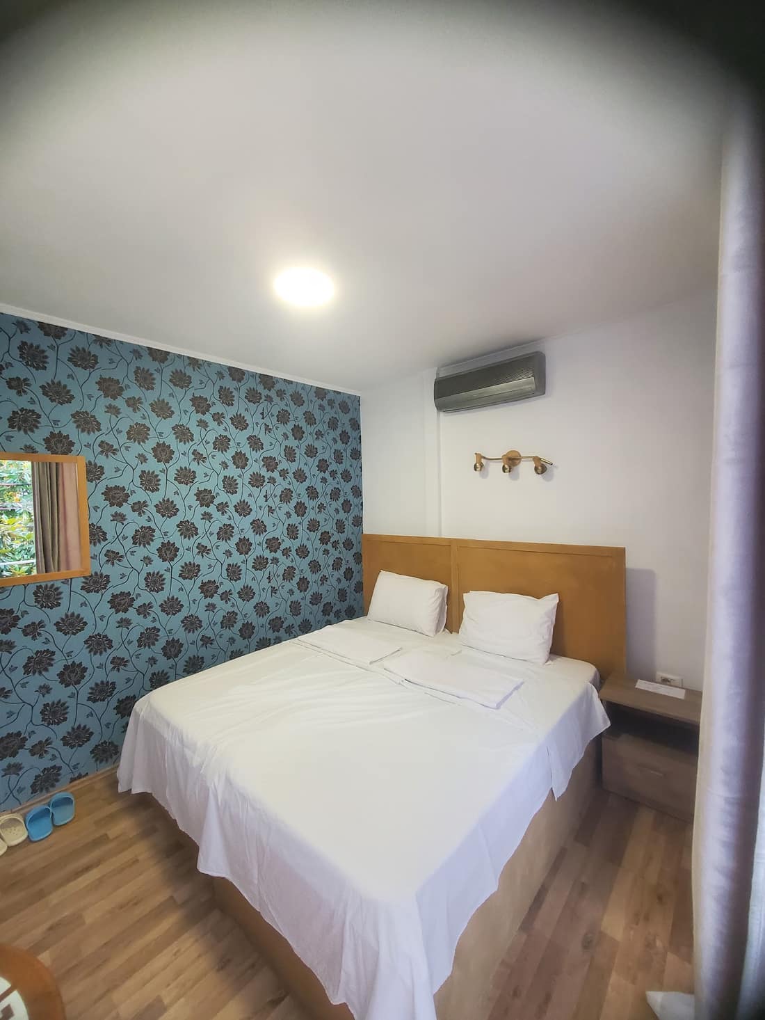 Room with two beds pushed together and a blue patterned wall