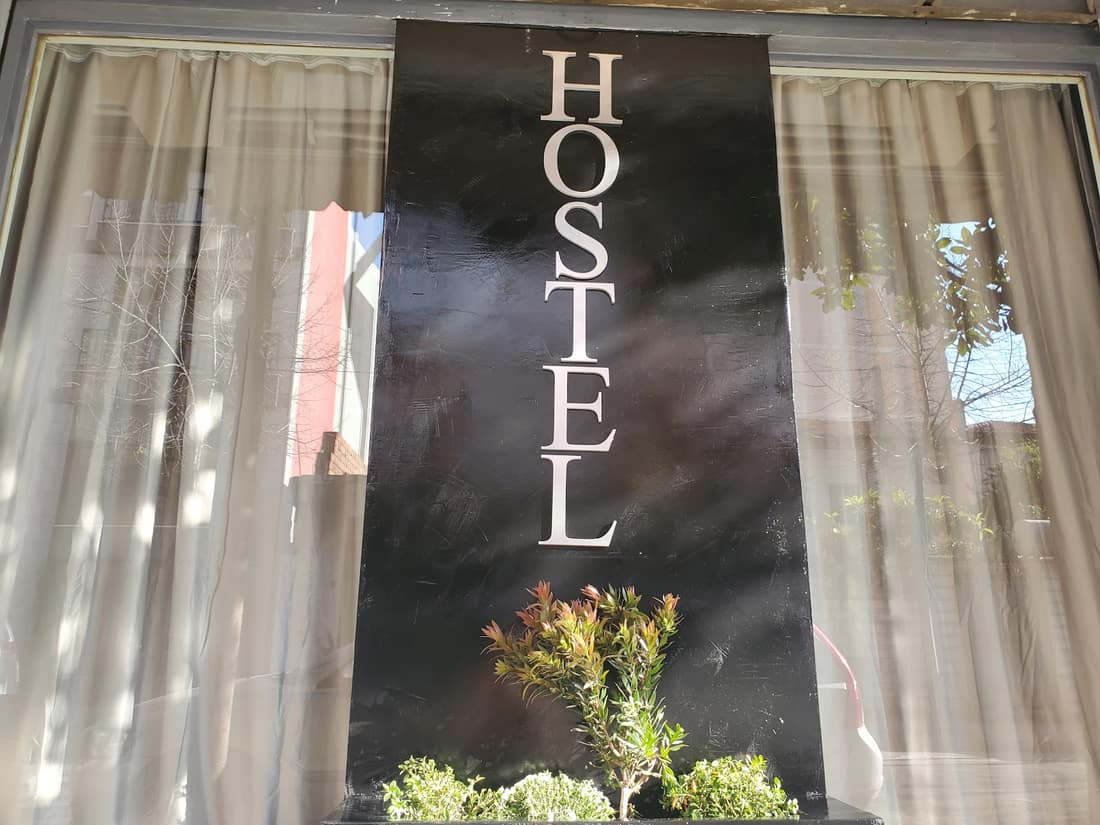 HOSTEL lettering in the front window in daylight